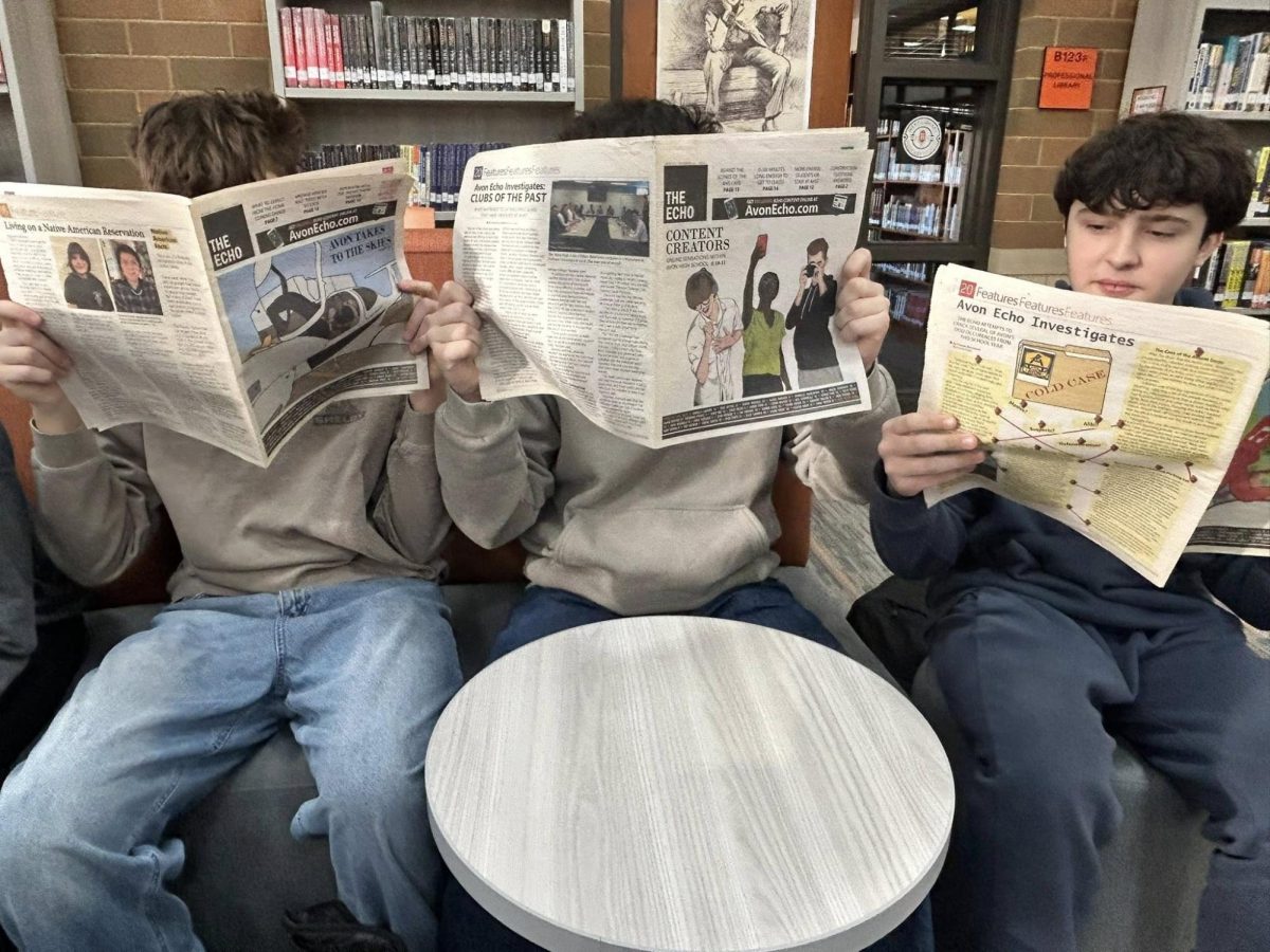 Students reading newspapers.  